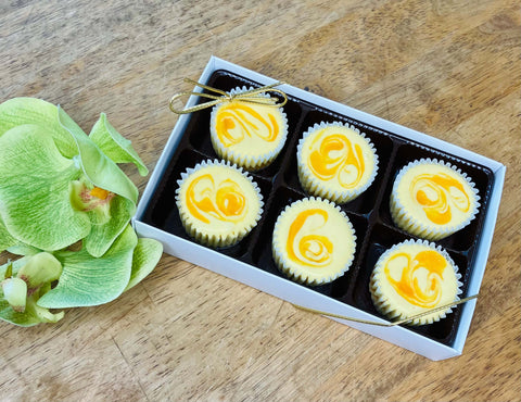 A beautifully packaged gift set of Mango Paradise Cheesecake Minis, perfect for a tropical-inspired treat.