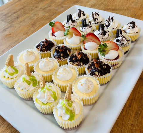 Assorted mini desserts on a white rectangular plate