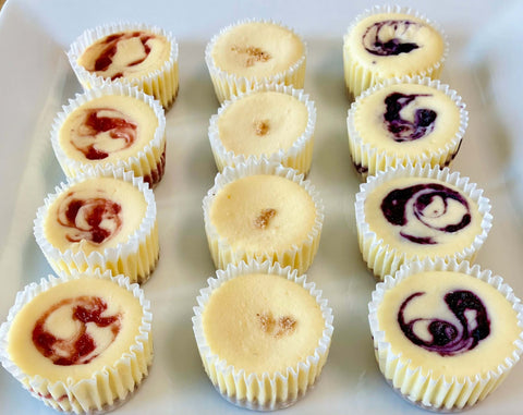 Summer berry mini cheesecakes on a white platter