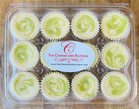 One dozen key lime minis in a closed clamshell package, with a Cheesecake Boutique sticker on top