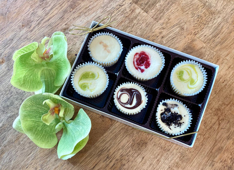 Beautifully packaged Signature Cheesecake Collection gift box with assorted gourmet cheesecake flavors.