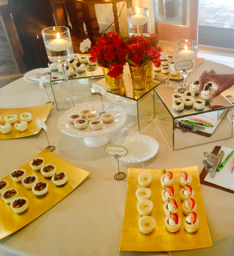 Elegant party table beautifully styled with garnished Fancy Cheesecake Bites minis, fresh flowers, and delicate decor, made in Fayetteville, GA for Metro Atlanta events.