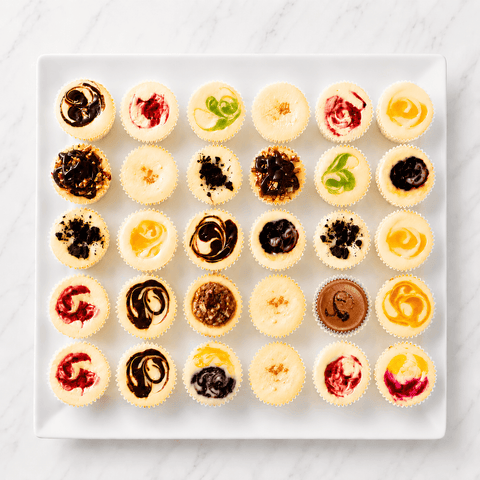 Ann assortment of mini cheesecakes in over 30 flavors on a white tray at The Cheesecake Boutique, FAyetteville, GA