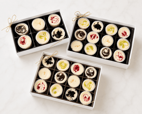 Three white cheesecake gift boxes filled with assorted handcrafted mini cheesecakes — available for pickup, local delivery, and nationwide shipping from The Cheesecake Boutique, Fayetteville GA