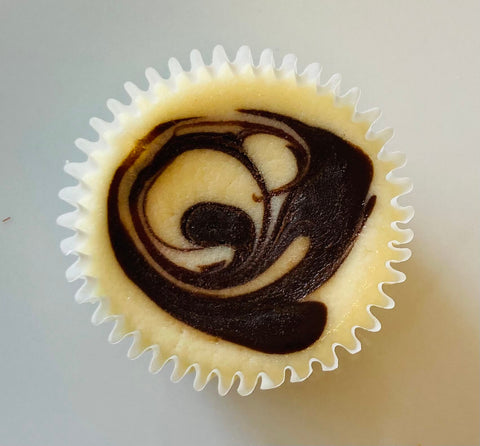 Singular marbled ganache cheesecake mini against a white background