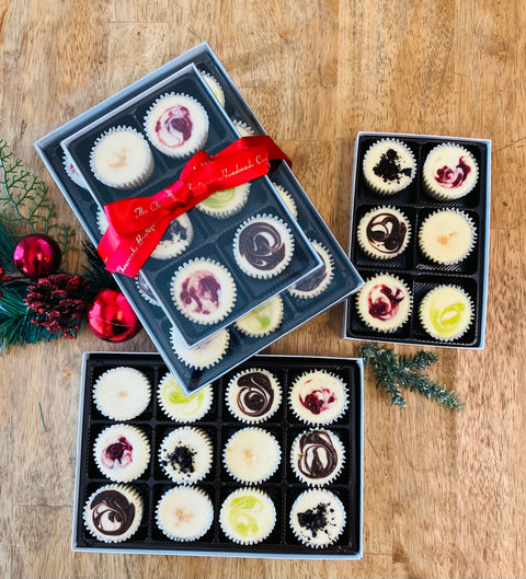 Assortment of bite-sized cheesecakes from the 18-piece Signature Gift Bundle, featuring creamy textures and gourmet flavors like Strawberry Swirl and Marbled Ganache, perfect for gifting or celebrations.