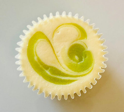 A singular key lime cheesecake mini on a white background