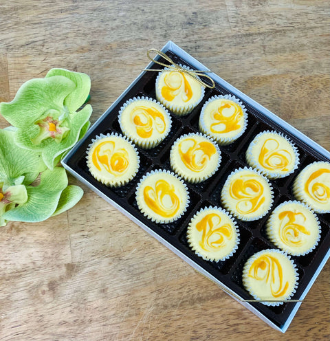 One dozen Mango Paradise cheesecakes in a gift box, top down