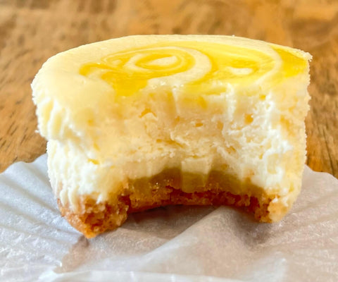 half eaten lemon curd cheesecake mini on a wooden surface