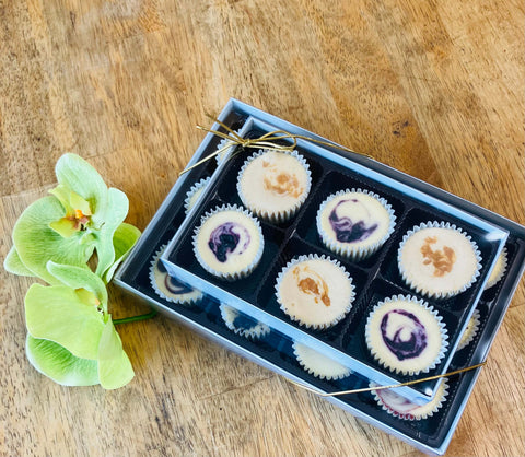 Stacked 12 piece and 6 piece gift boxes with classic and seasonal flavored cheesecake minis.