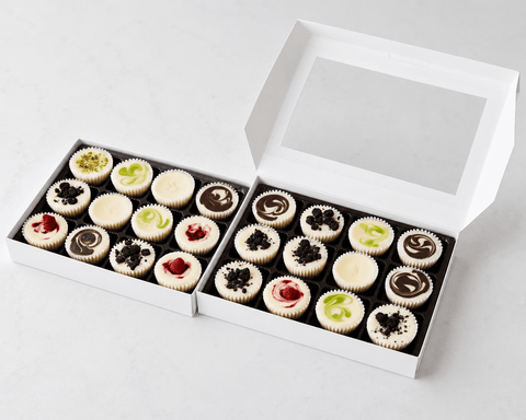 Box of assorted mini cheesecakes with on a white background