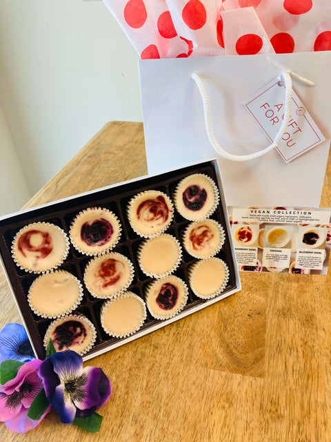 a gift box of assorted vegan mini cheesecakes with a gift bag.  Perfect for vegan cheesecake lovers this holiday